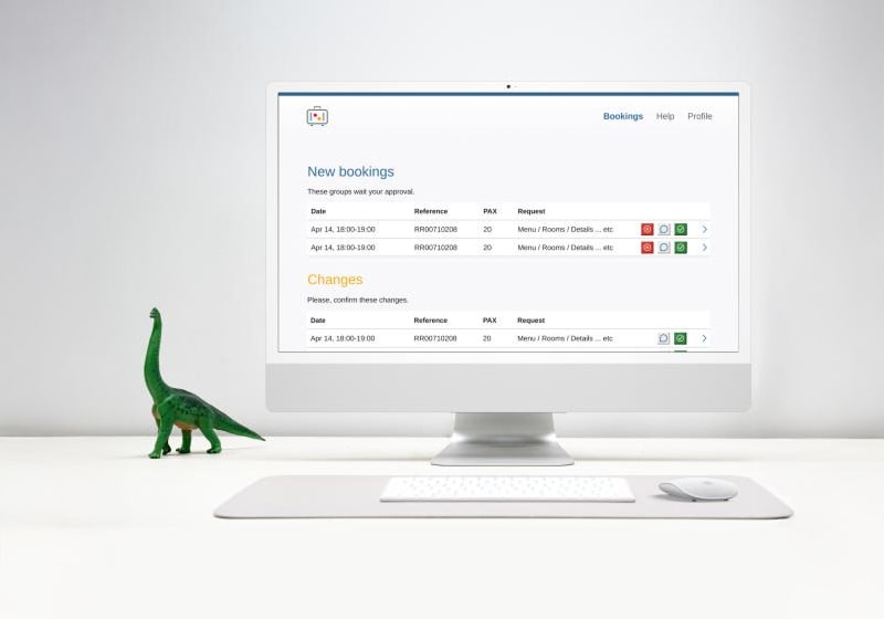 KT - Photo of a toy dinosaur and computer