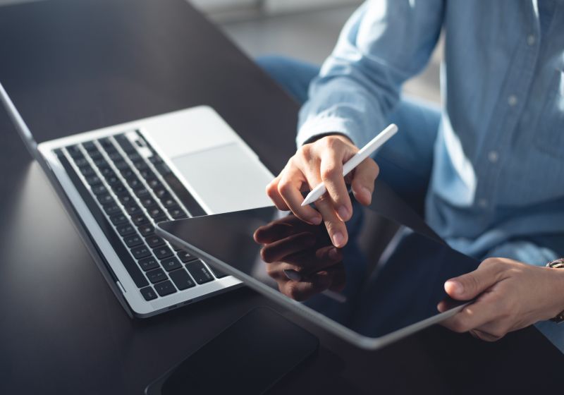KT - Image of a male businessmen using tablet and laptop