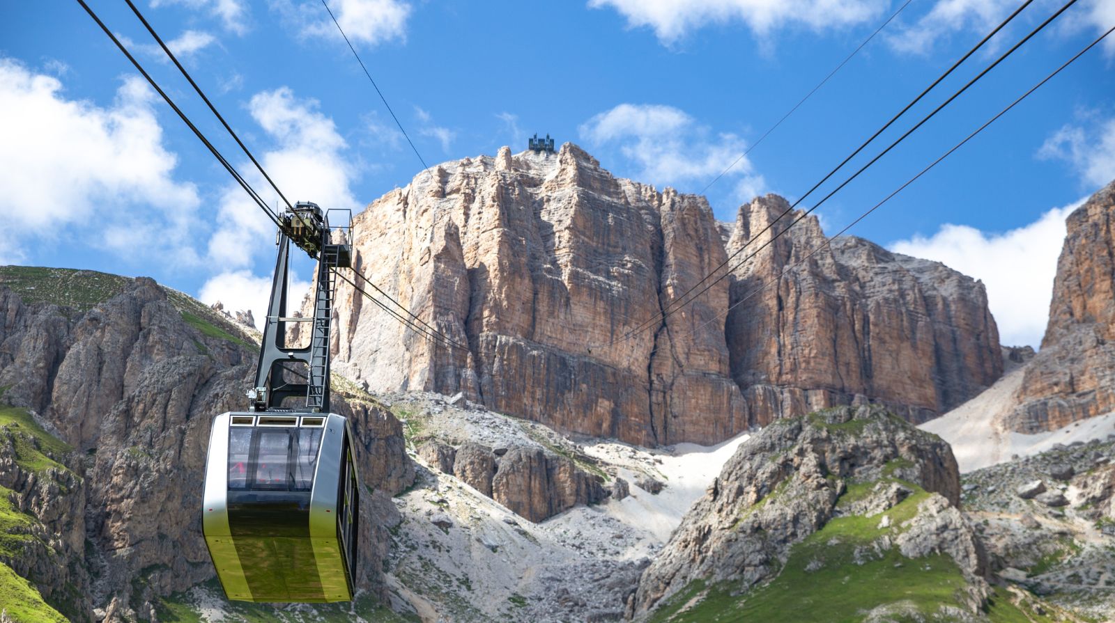 Sass Pordoi cable car ascending above the Dolomites mountains, Trentino Alto Adige, Italy
