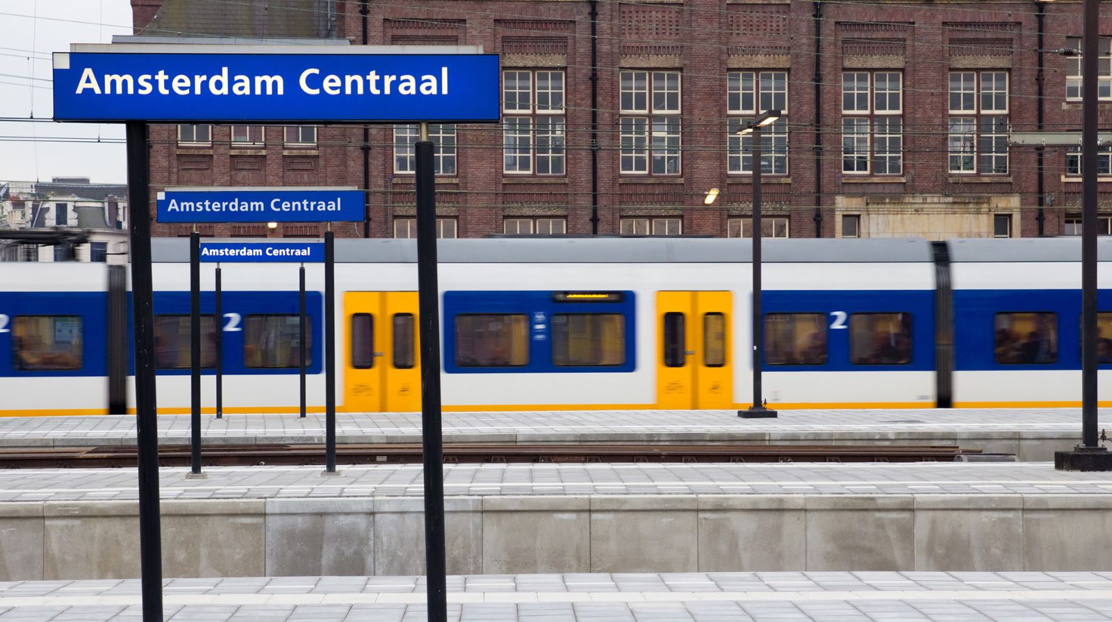 Travellers at the historic Amsterdam Central Station railway terminal.
