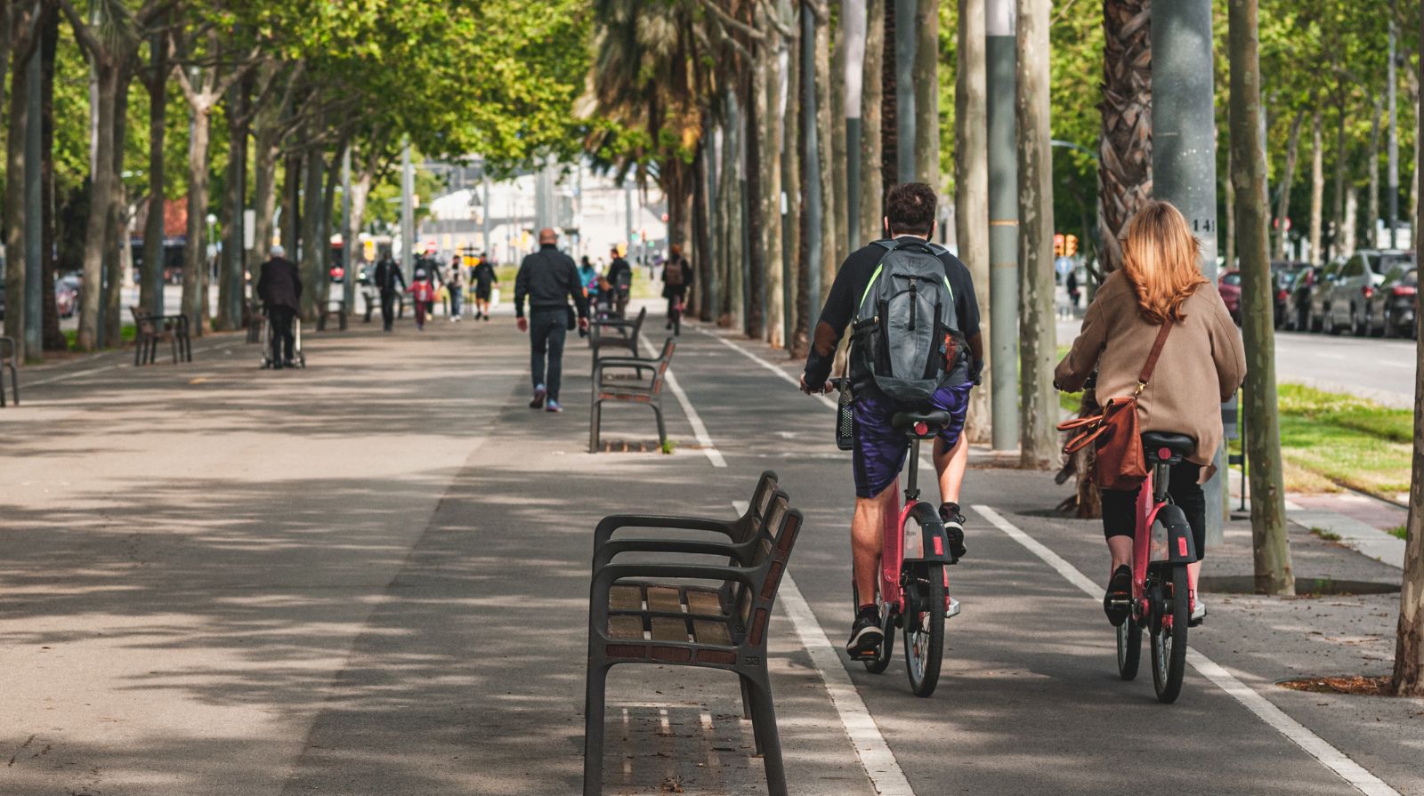 People exploring the streets of Barcelona by bike.