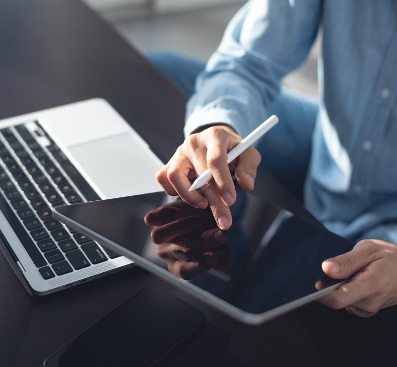 KT - Man writing on his Ipad