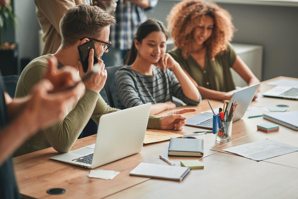 Group of employees at the office discussing projects