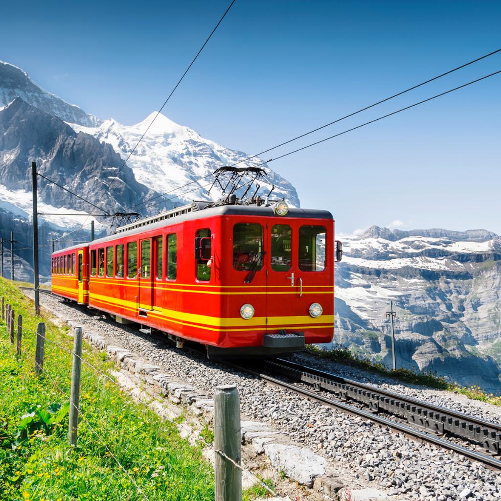 Train going through the mountains during sunny weather