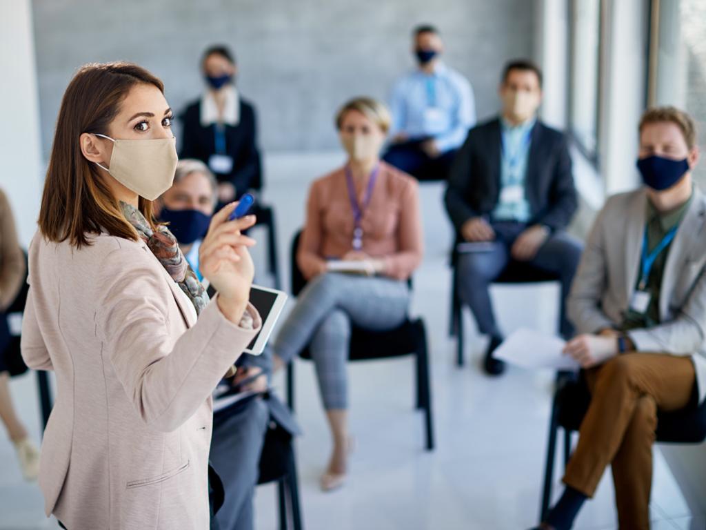 People attending a meeting wearing face masks