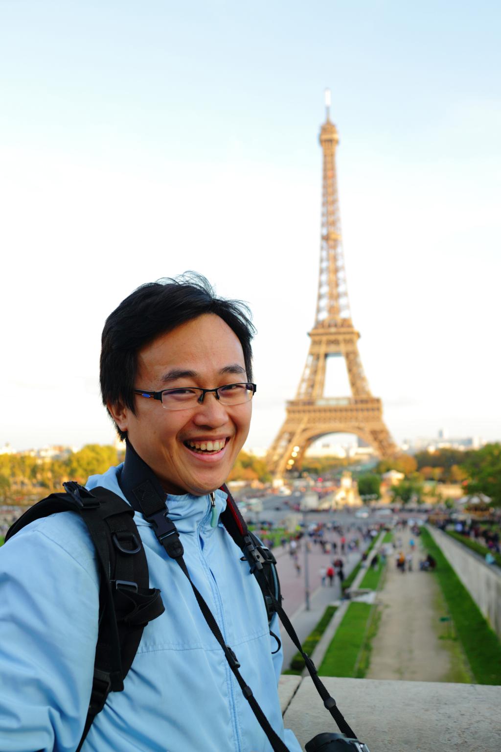 Laughing tourist in front of the Eiffel tower 